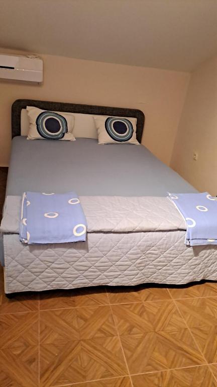a bed with two pillows on top of it at Vila Vesna in Gornji Karin