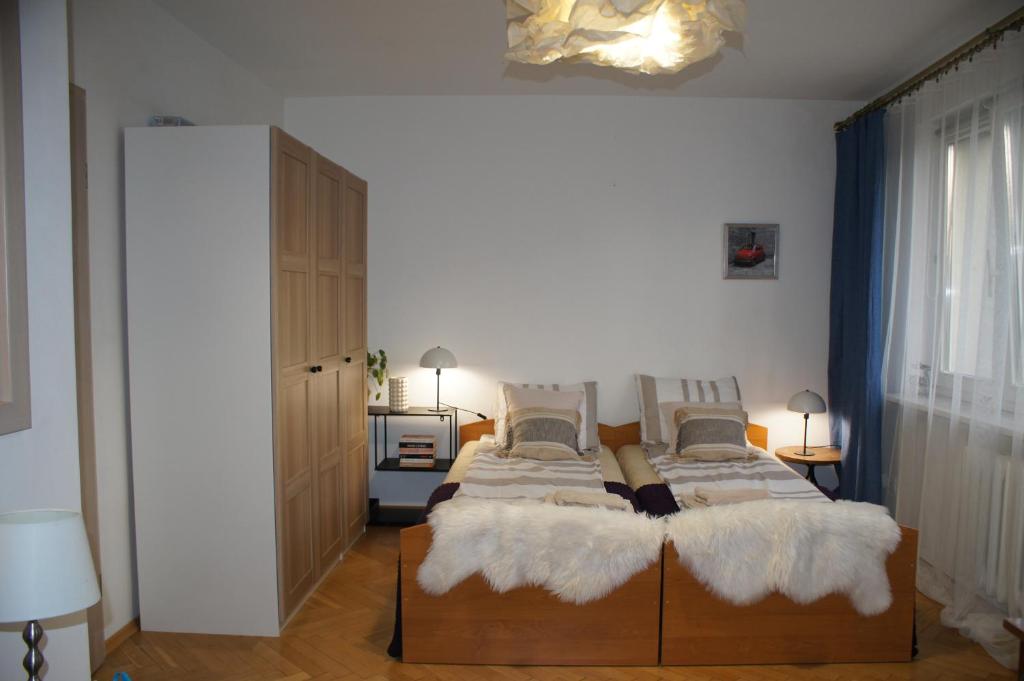 a bedroom with two beds with white blankets at Apartament Pułaskiego in Rzeszów