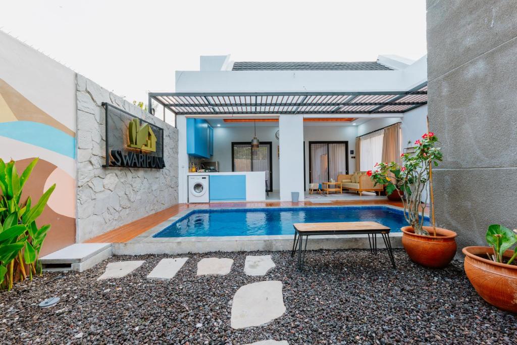 a pool in the middle of a house at Swaripuna Villa by Nandara Hospitality in Salakan