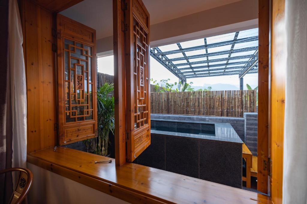 a view from the window of a house with a swimming pool at 青城山泉青小院温泉中式民宿 in Taiping