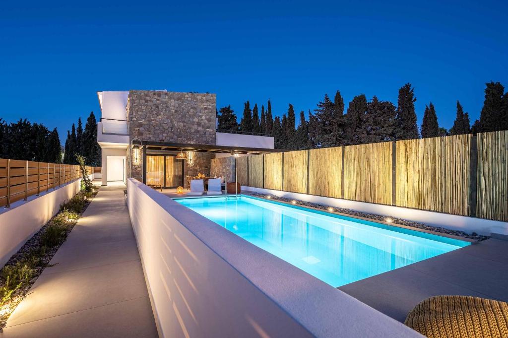 a swimming pool in the backyard of a house at Rastoni Villas in Psalidi