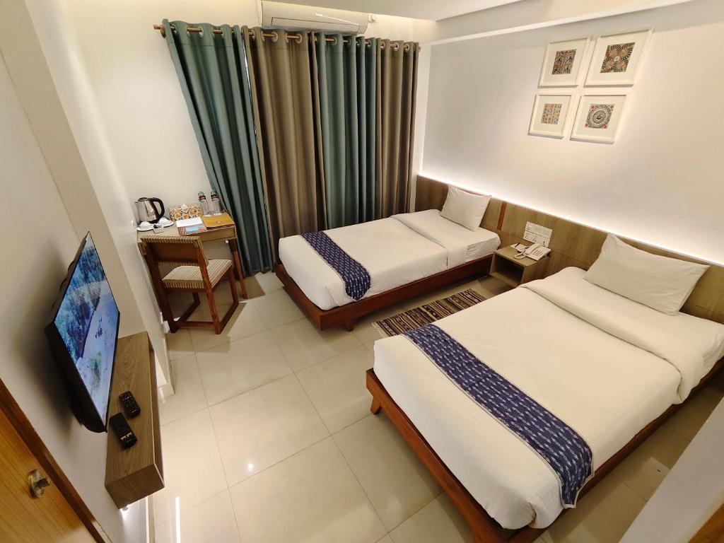 Postel nebo postele na pokoji v ubytování Hotel Nandini