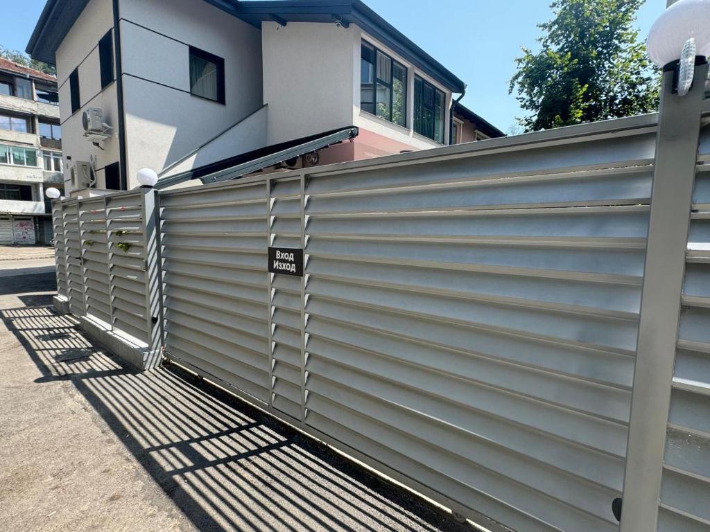 a metal fence in front of a house at Luxurious House with three Deluxe rooms & Free Parking in Sofia