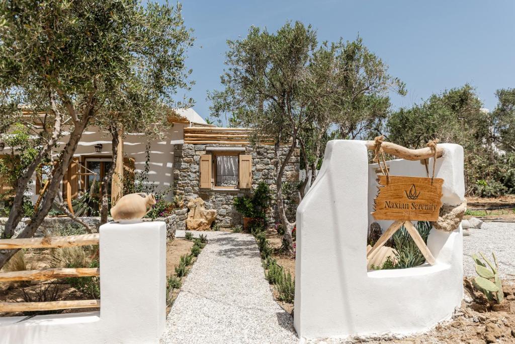 a garden with a slide in front of a house at Naxian Serenity Suites in Agia Anna Naxos