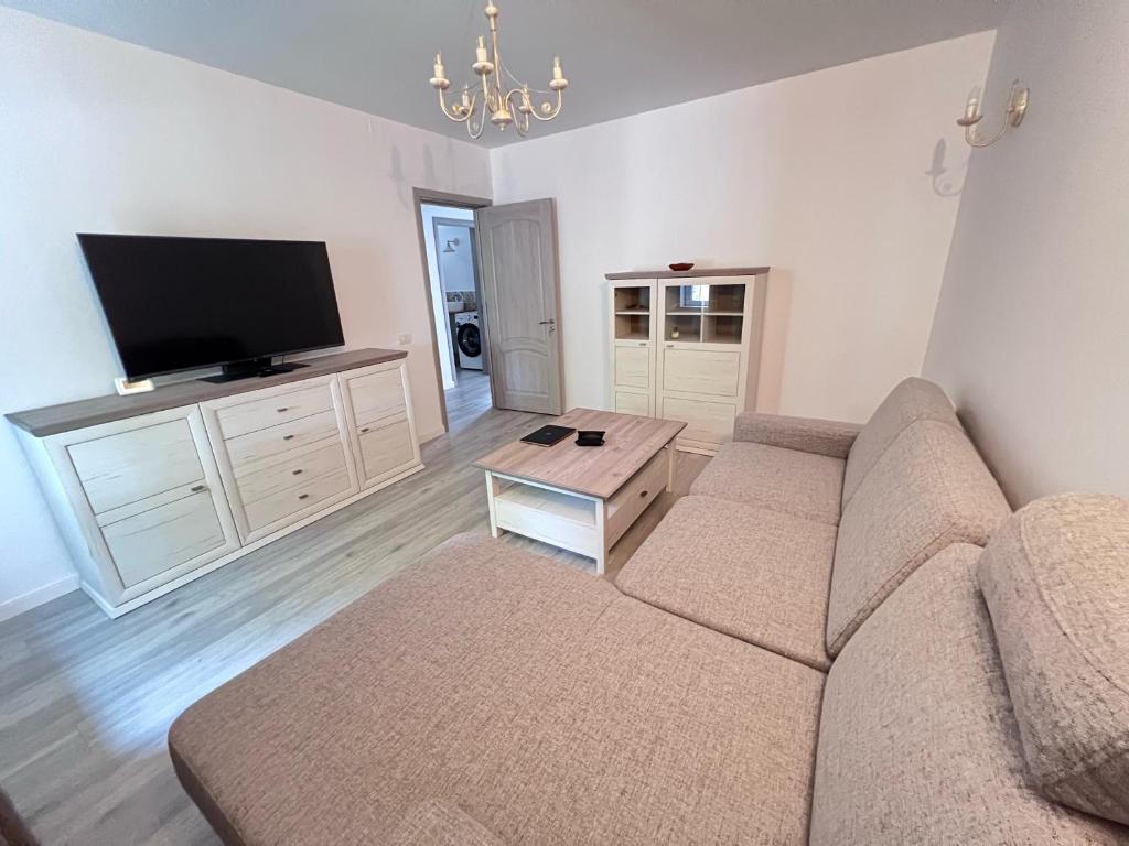a living room with a couch and a flat screen tv at Casa Paraiso Constanta City in Constanţa