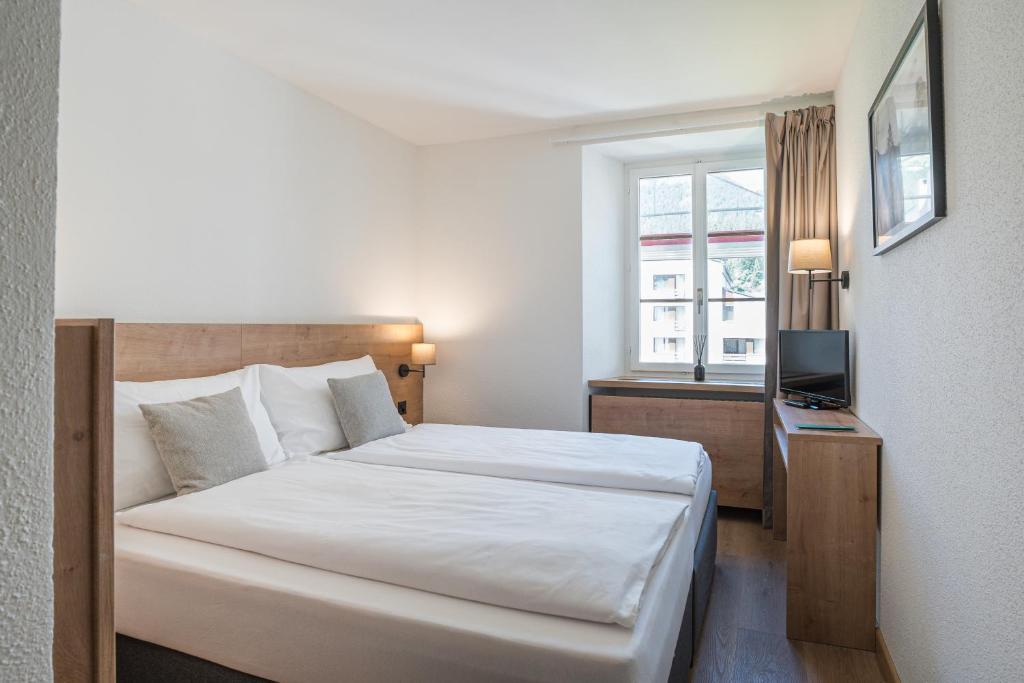 Postel nebo postele na pokoji v ubytování Hotel Brocco & Posta