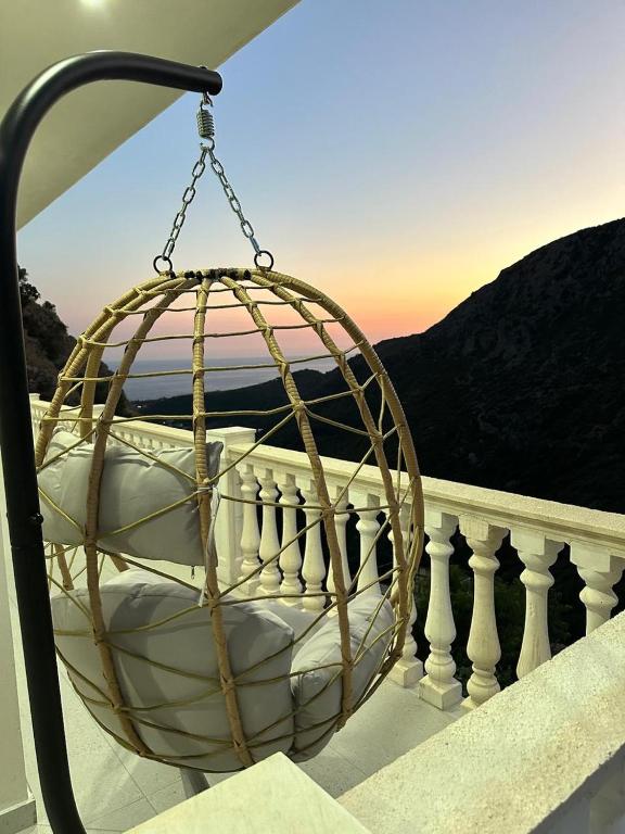 a hanging basket on a balcony with a view at SWEET HOME 1 in Himare