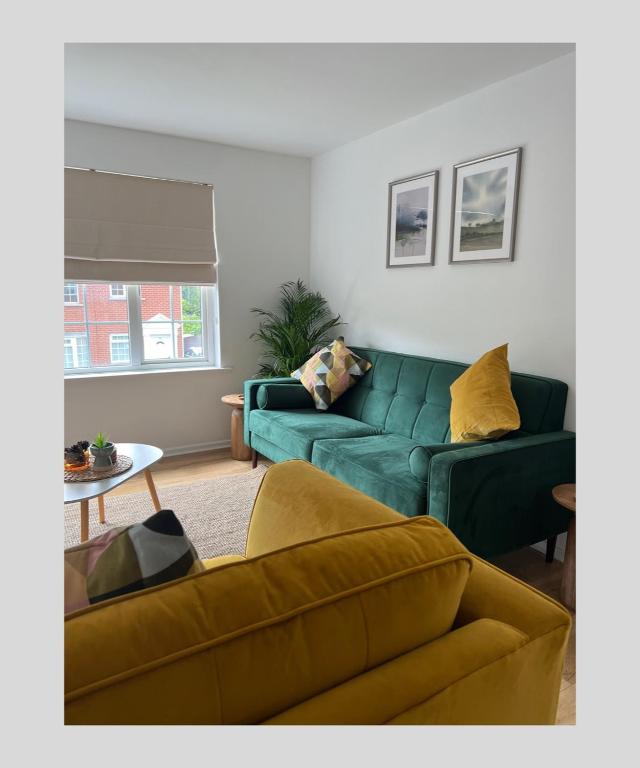 a living room with a green couch and a table at Holywood Halt in Holywood