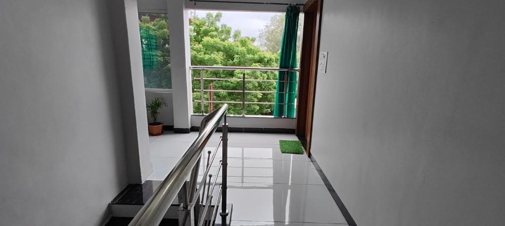 an empty hallway with a window and a staircase at TARA Guest House in Ujjain