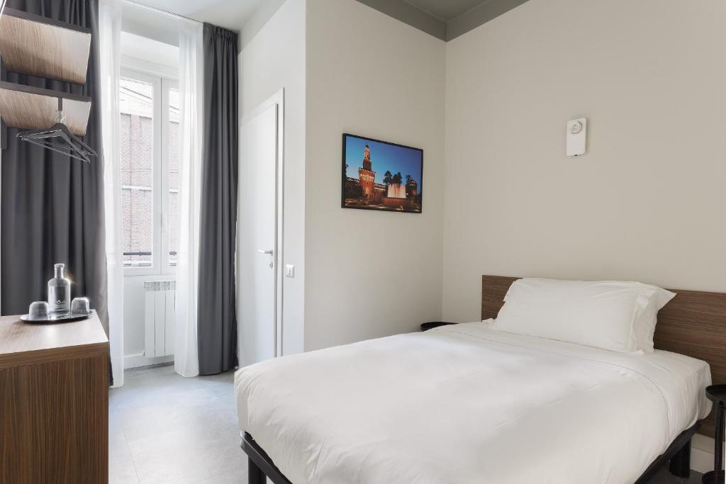 Postel nebo postele na pokoji v ubytování Hotel 22 Marzo