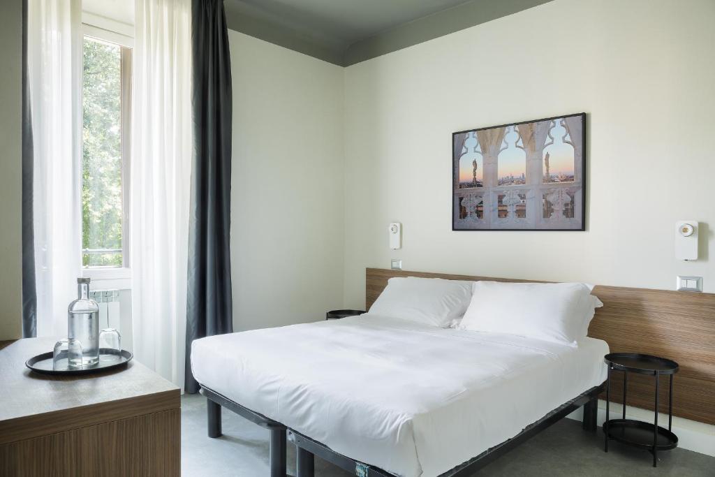 Postel nebo postele na pokoji v ubytování Hotel 22 Marzo