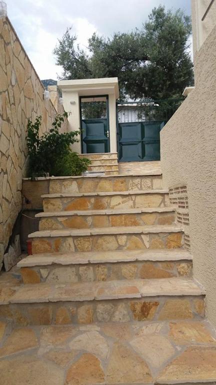 a set of stone stairs leading to a house at El Doro Rooms in Dhërmi