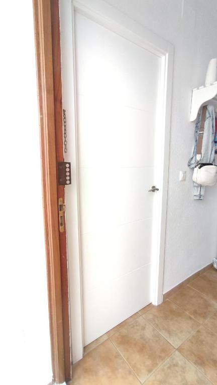 a door leading into a hallway with a tile floor at Apartamento en el Portil in El Portil