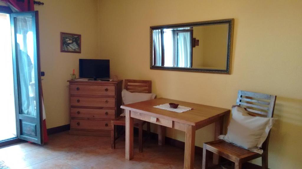 Un comedor con una mesa y un espejo. en Casa Rural Aristondo Agroturismo, en San Sebastián