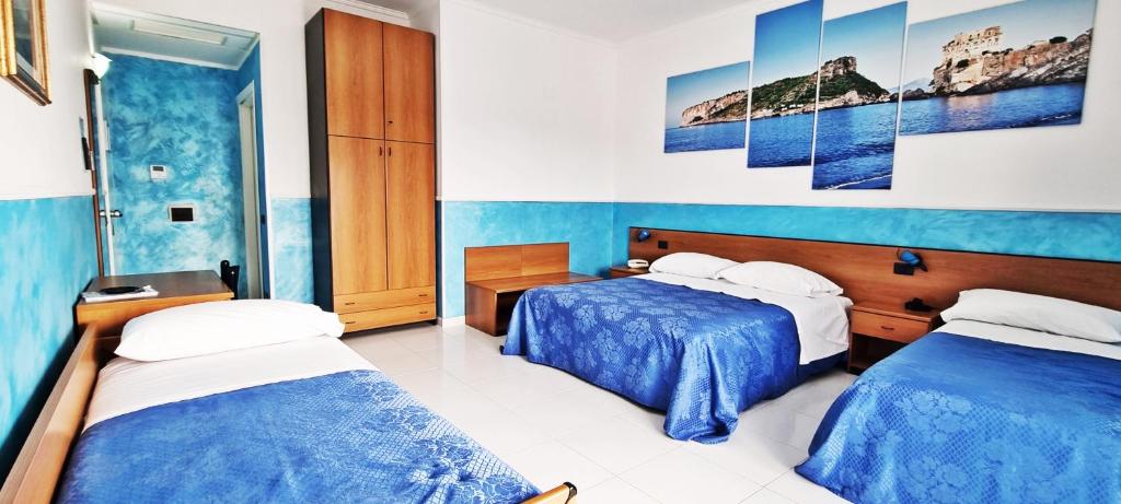 Postel nebo postele na pokoji v ubytování Hotel Blu Eden