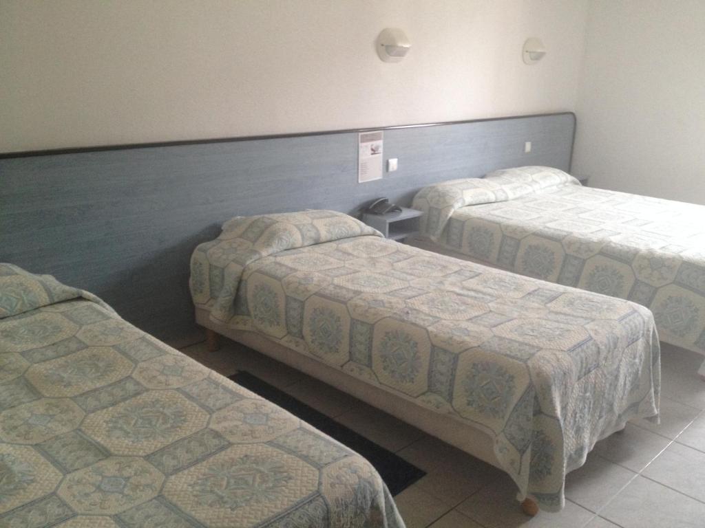 Postel nebo postele na pokoji v ubytování Hotel Le Strasbourg