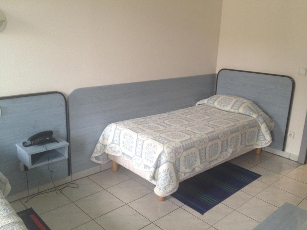 Postel nebo postele na pokoji v ubytování Hotel Le Strasbourg
