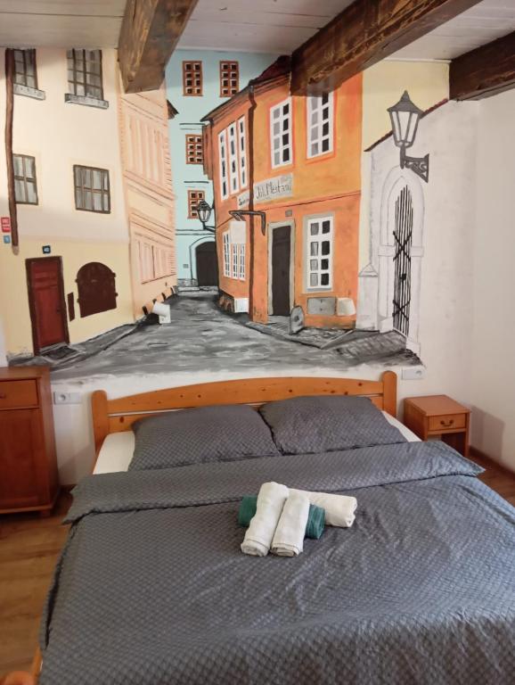 a bedroom with a bed with a painting on the wall at Prague centrum house in Prague