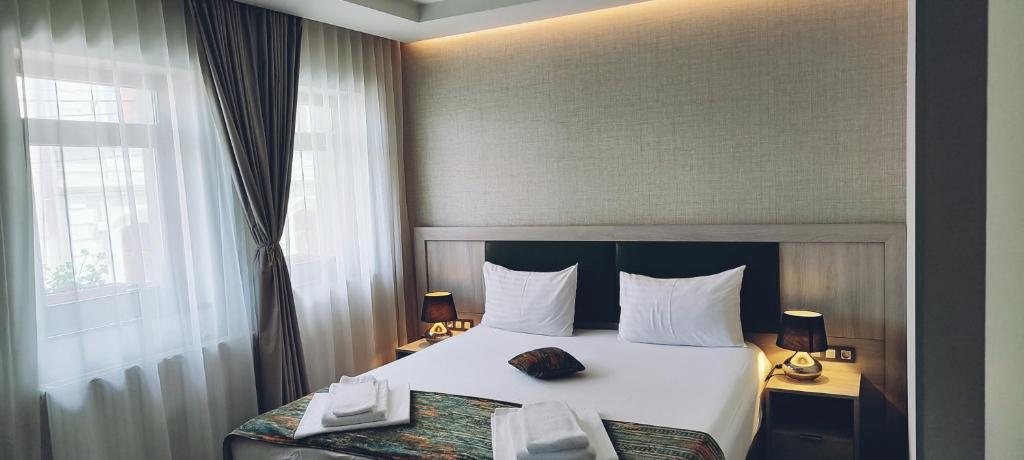 a hotel room with a bed and a window at Pensiunea Luceafărul Sibiu in Sibiu