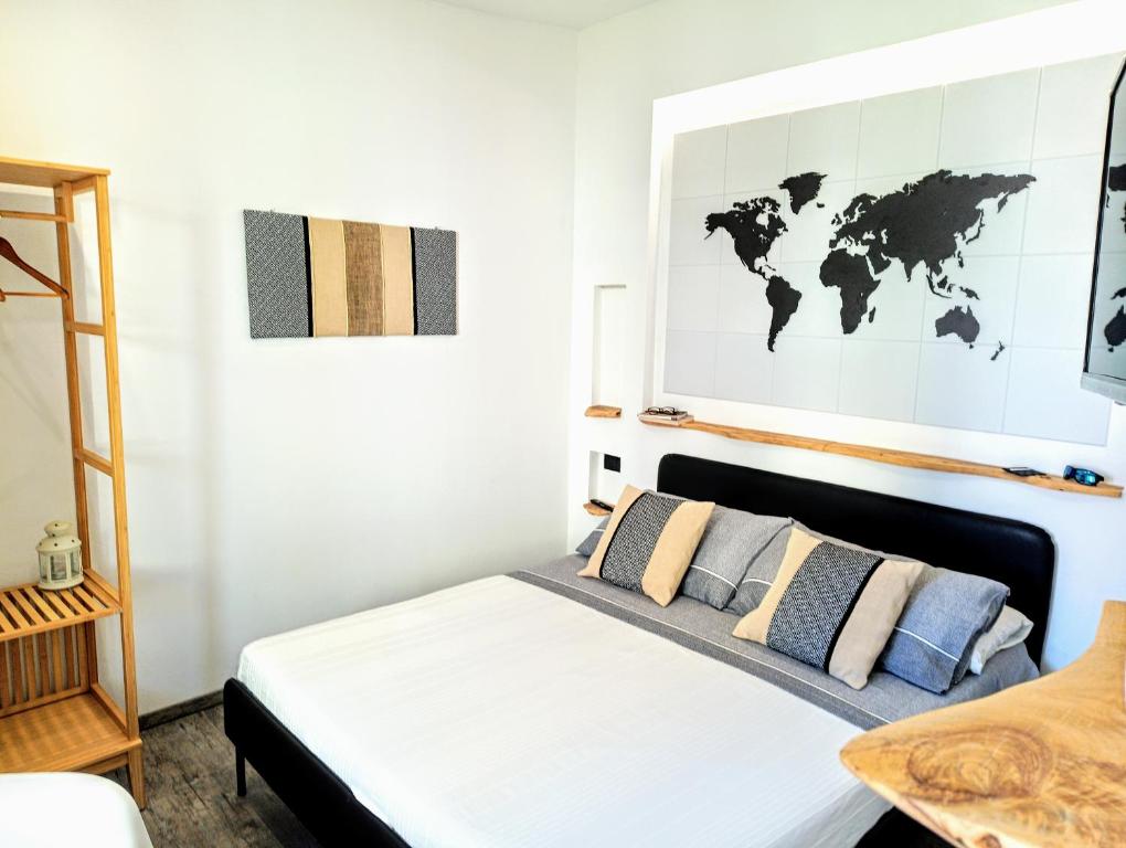 a bedroom with a bed with a map on the wall at La GemMa in Santa Maria Navarrese