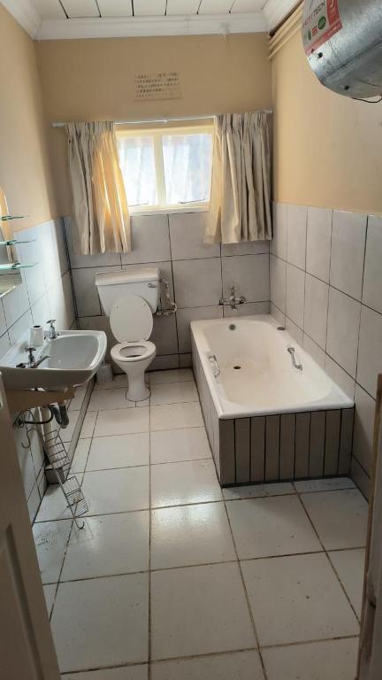 a bathroom with a tub and a toilet and a sink at Shaw House 1 in Denysville