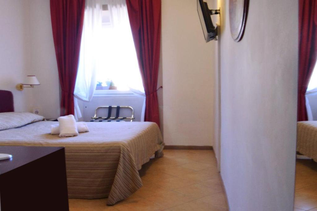 A bed or beds in a room at Hotel Cardinal of Florence - recommended for ages 25 to 55