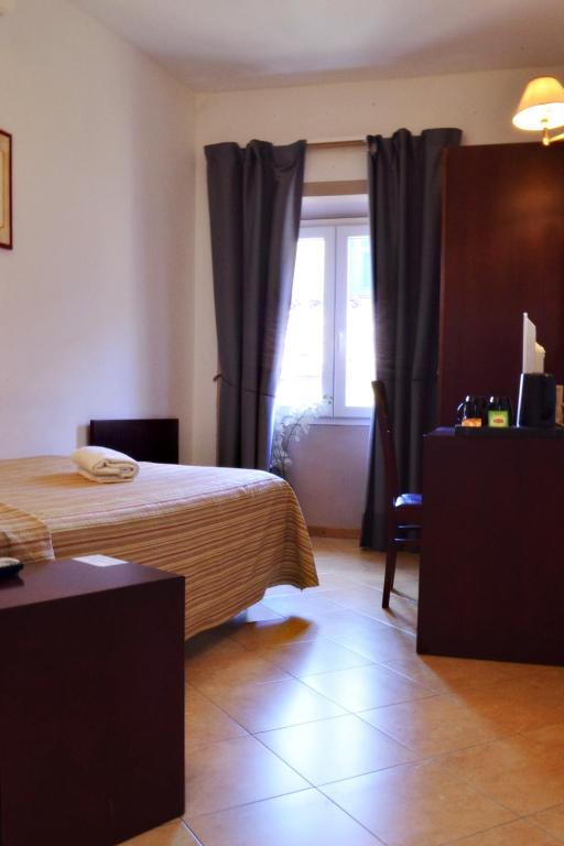 A bed or beds in a room at Hotel Cardinal of Florence - recommended for ages 25 to 55