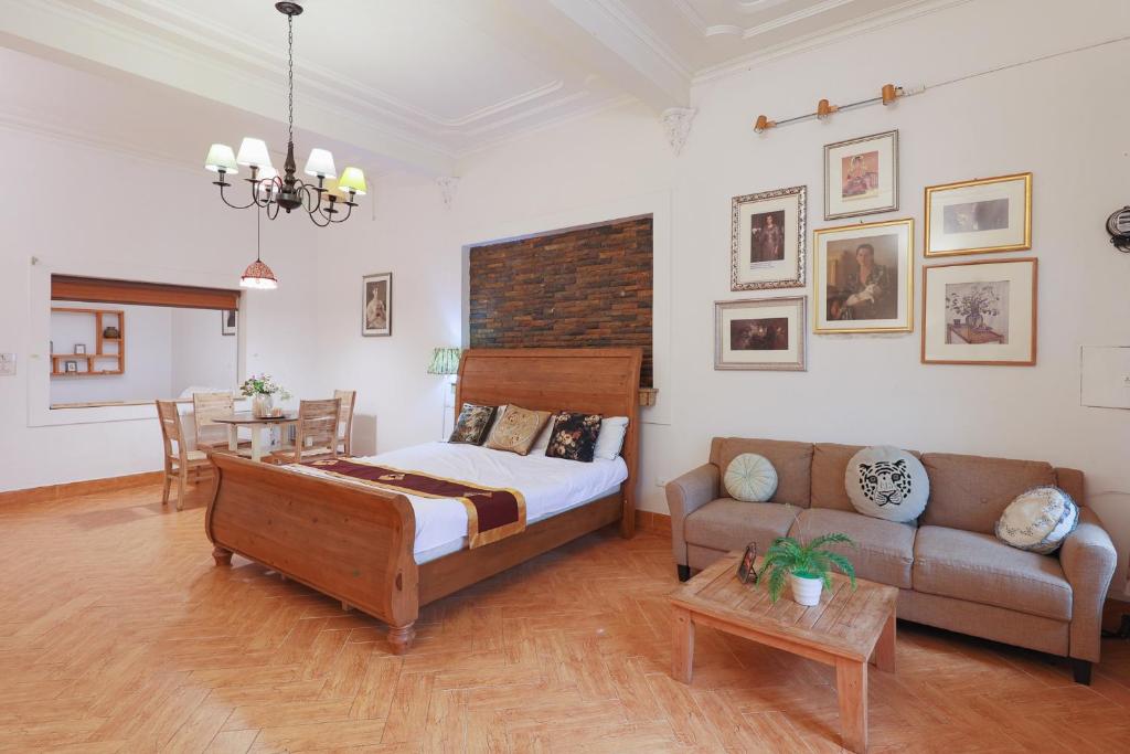 a bedroom with a bed and a couch and a table at Cozy Fun Homestay 12 in Hanoi