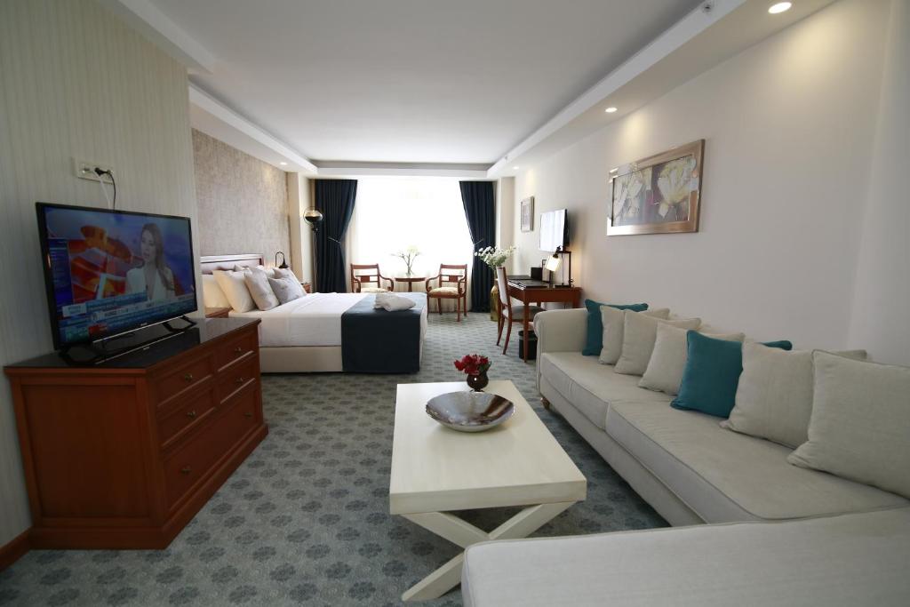 A bed or beds in a room at Tuzla Garden Hotel & Spa