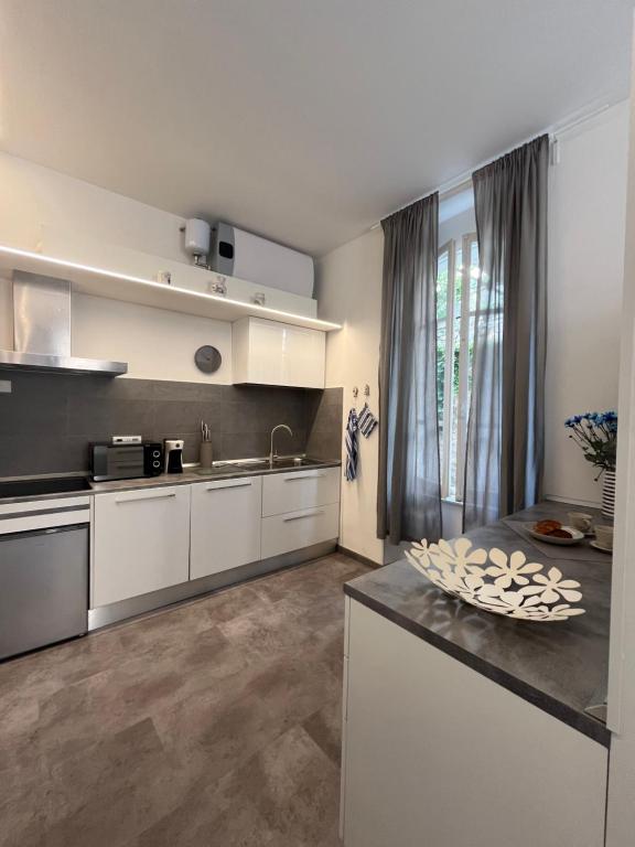 a kitchen with white cabinets and a counter top at Le Finestre Veneris in Portovenere