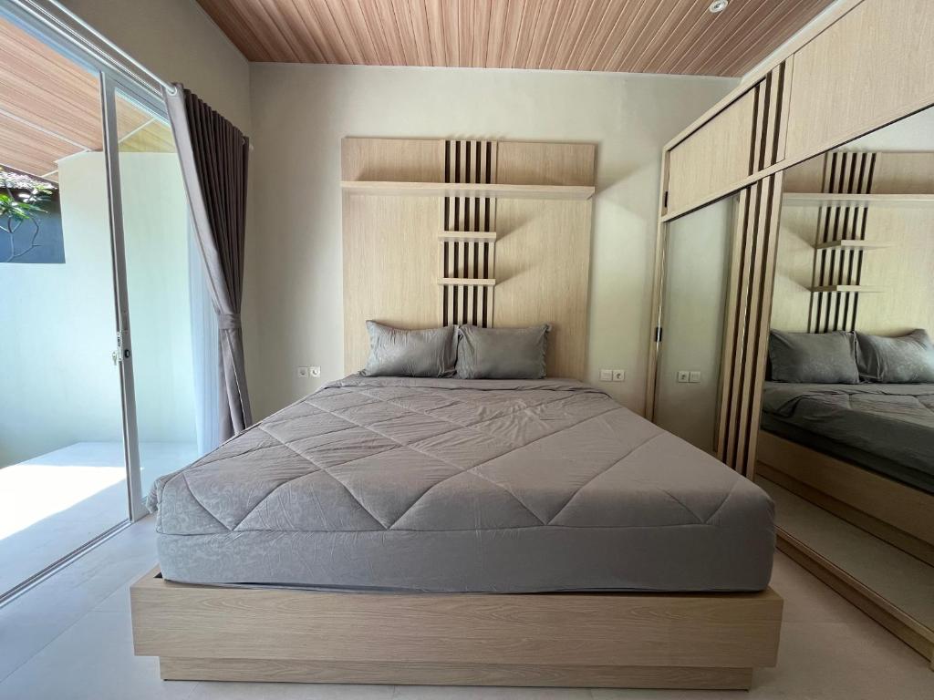Postel nebo postele na pokoji v ubytování Gandatera Ubud