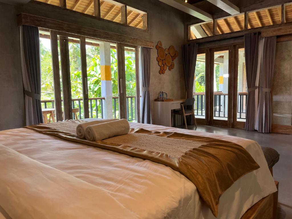 Postel nebo postele na pokoji v ubytování Gandatera Ubud