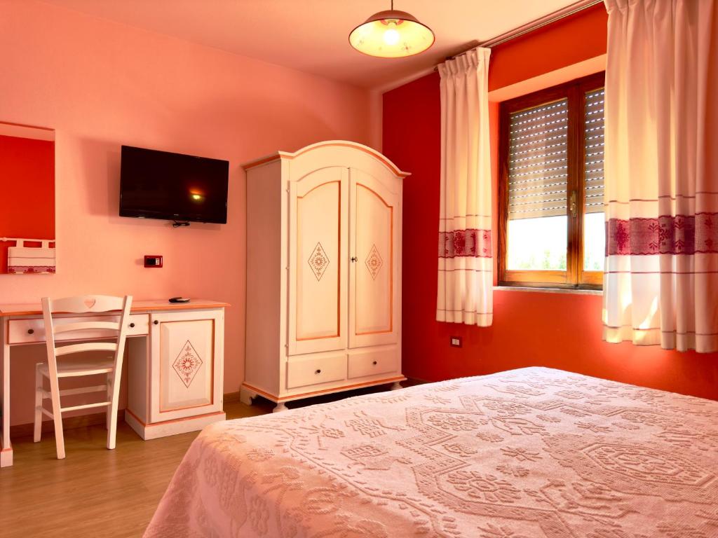 Łóżko lub łóżka w pokoju w obiekcie B&B Selvaggio Blu