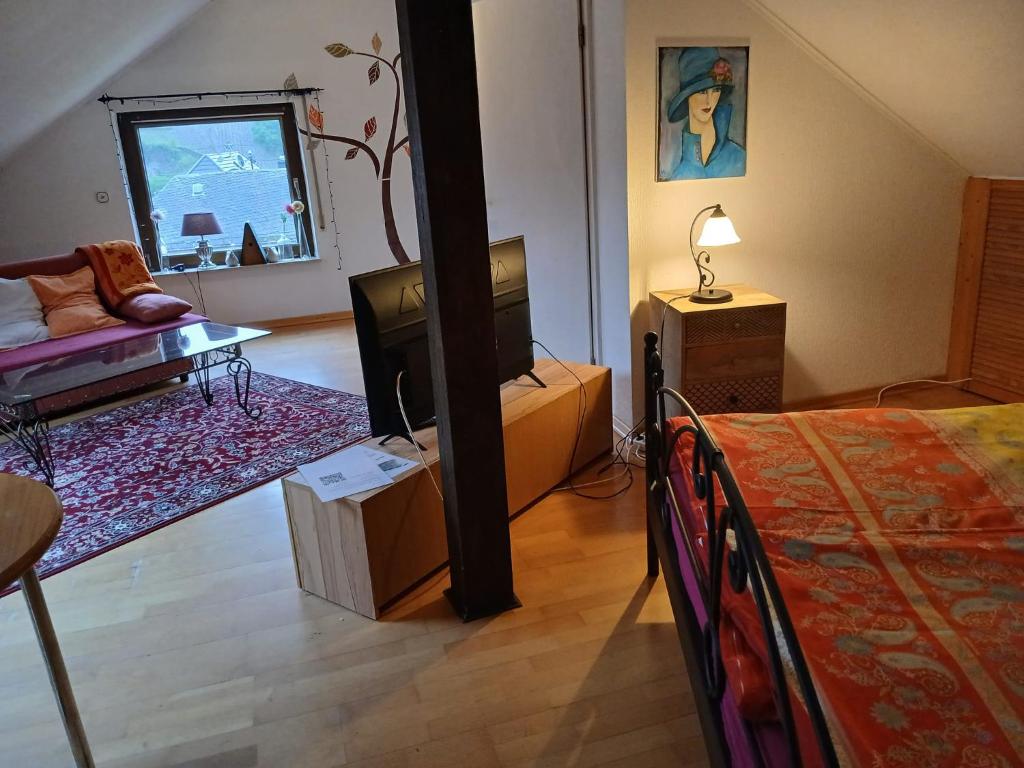 Zimmer mit einem Schlafzimmer mit einem Bett und einem TV in der Unterkunft Ferienwohnung mit Moselblick in Piesport