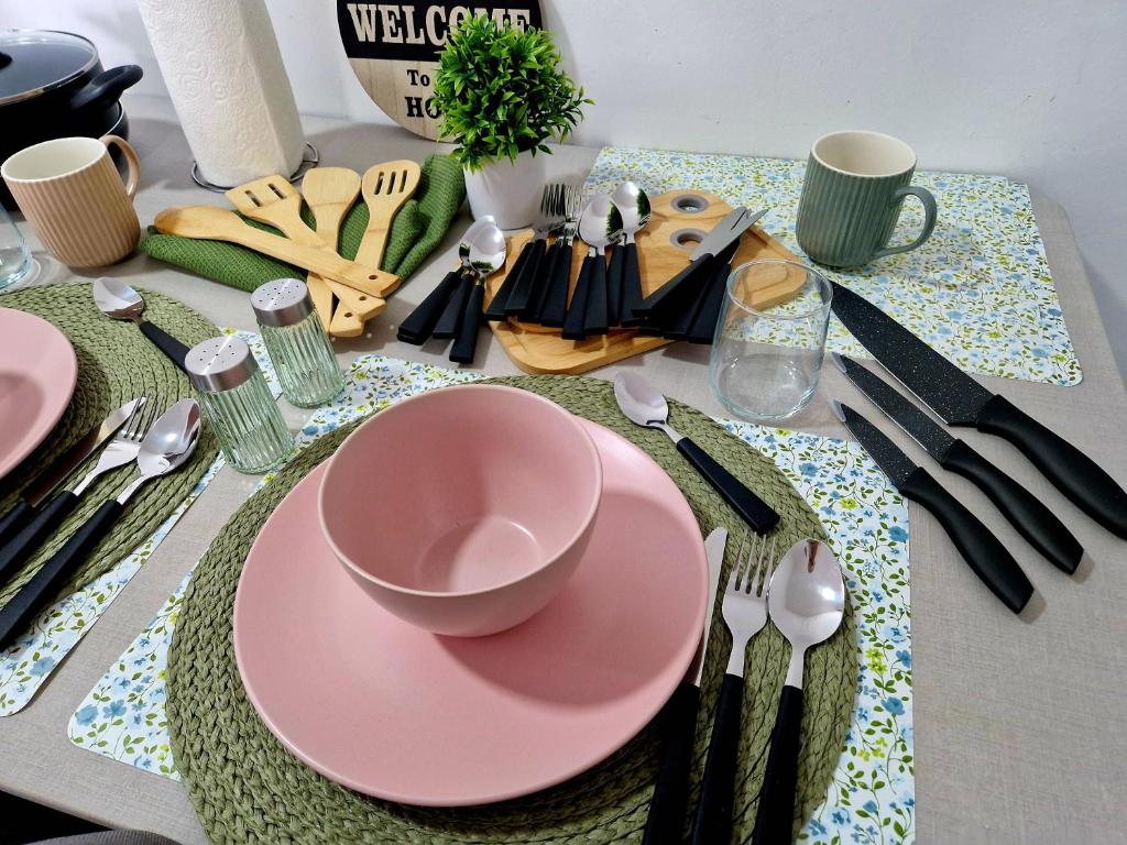 a table with a pink plate and fork and knife at Infinity Apartment & Free Wifi & Free Parking in Sarajevo
