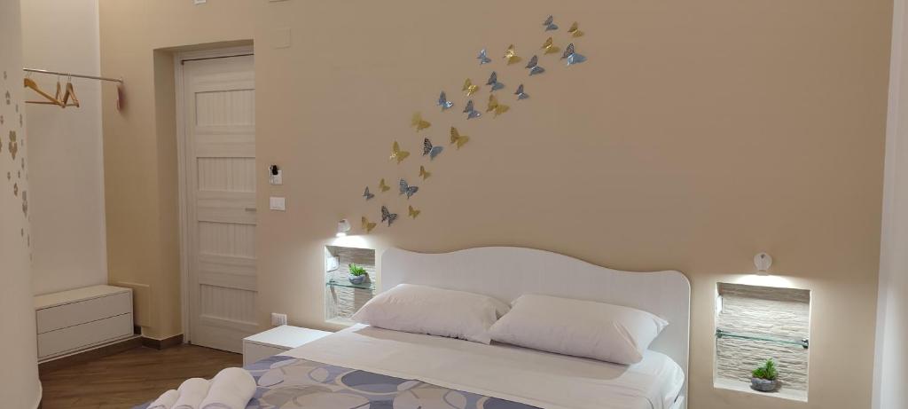 a bedroom with a bed with stars on the wall at Balarm Central Apartment in Palermo