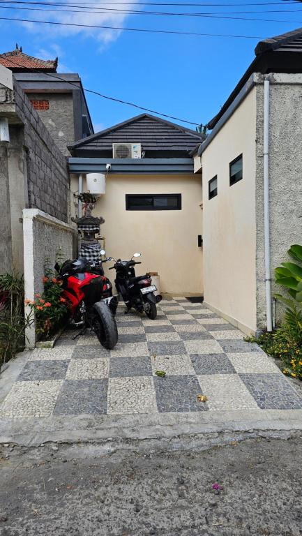 two motorcycles parked in front of a garage at LM Home Mendira in Candidasa