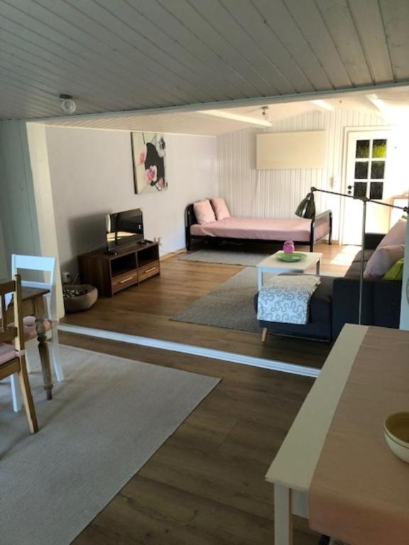 a living room with a couch and a table at gemütliches Blockhaus - das Hundeparadies am Wald in Wiehl