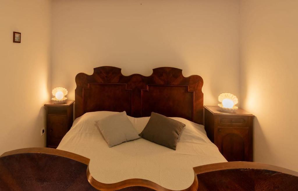 a bedroom with a bed with two chairs and two lamps at Fiammetta in Rovinj