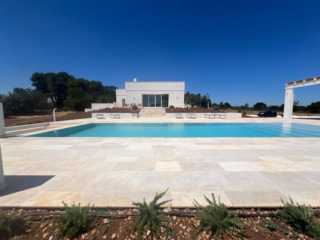 a swimming pool in front of a villa at Residenza del Duca in Martina Franca