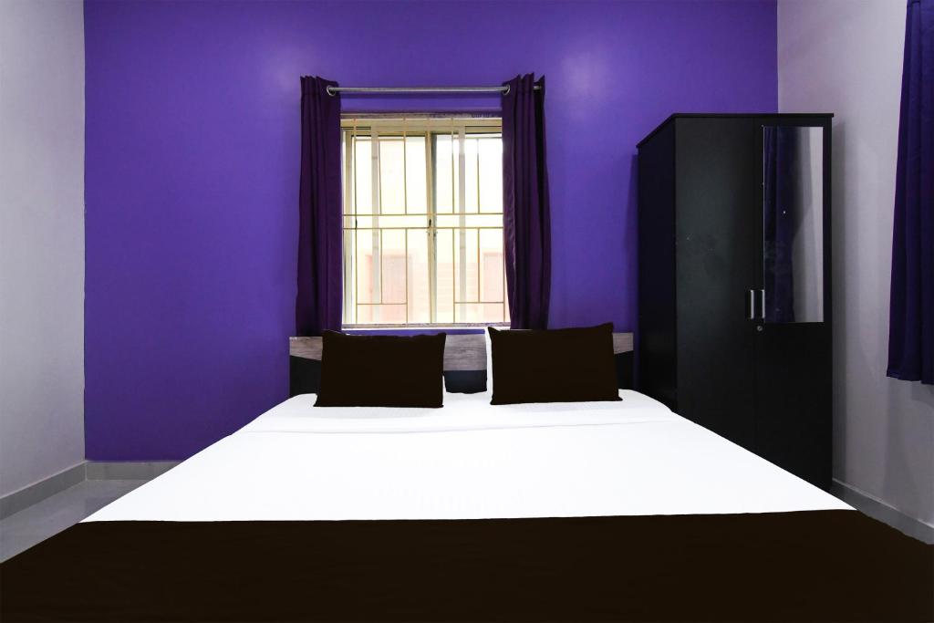 Postel nebo postele na pokoji v ubytování Super Hotel O MNJ Mansion