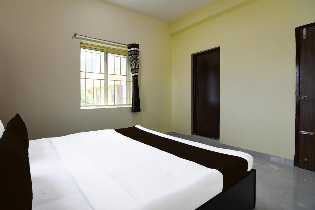 Postel nebo postele na pokoji v ubytování Super Hotel O MNJ Mansion