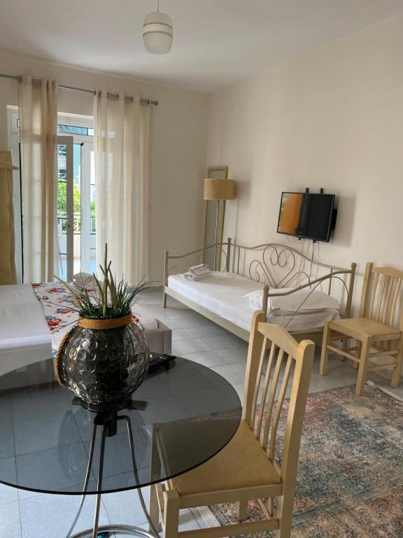 a living room with a table and a bedroom at Mimi's Apartments in Vlorë