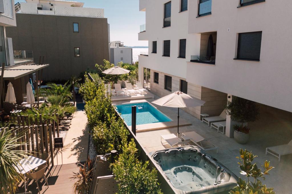 an outdoor swimming pool next to a building at Adria Concept Suites in Zadar