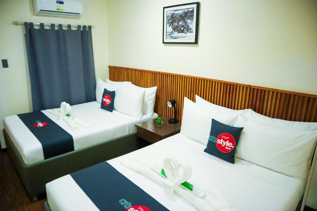 Postel nebo postele na pokoji v ubytování Citistyle Inn