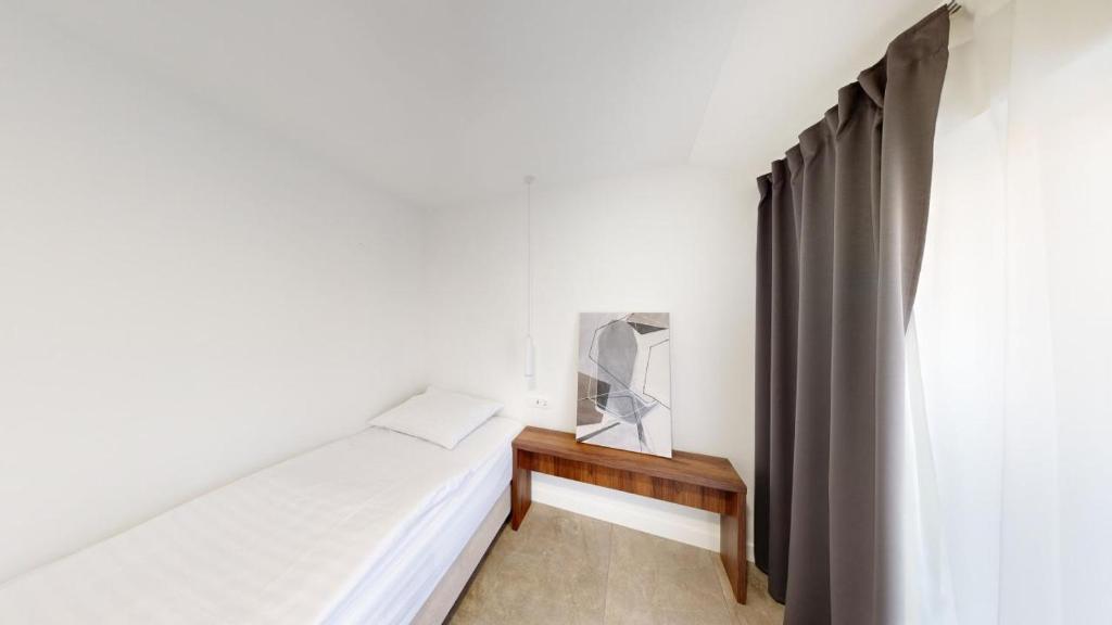 Postel nebo postele na pokoji v ubytování Calypso Residence