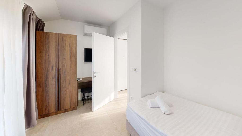 Postel nebo postele na pokoji v ubytování Calypso Residence