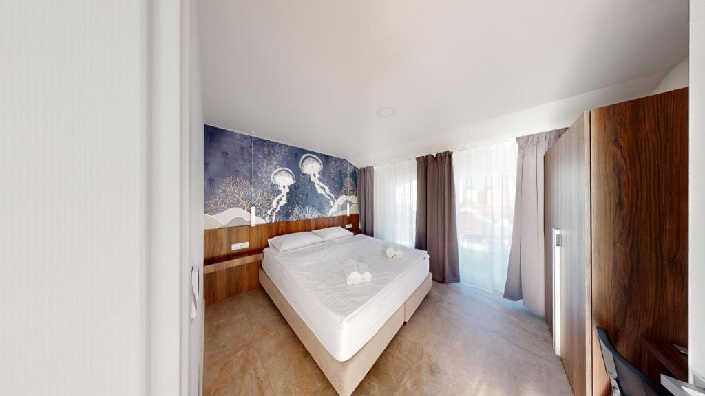 Postel nebo postele na pokoji v ubytování Calypso Residence