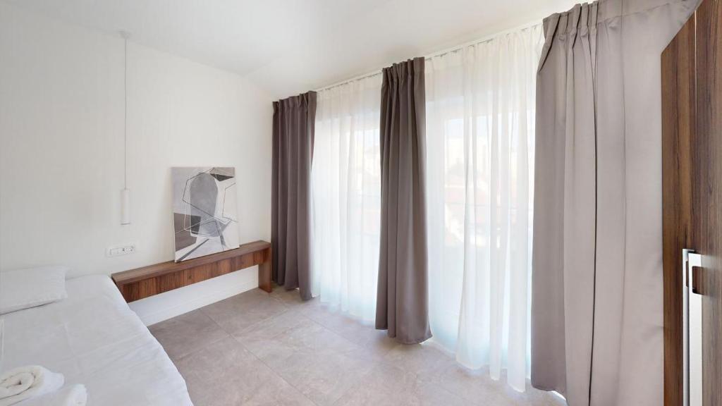 Postel nebo postele na pokoji v ubytování Calypso Residence