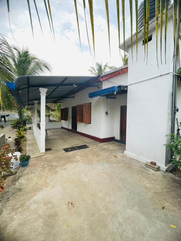a house with a roof on the side of it at Joes Resthouse in Oddaimavadi